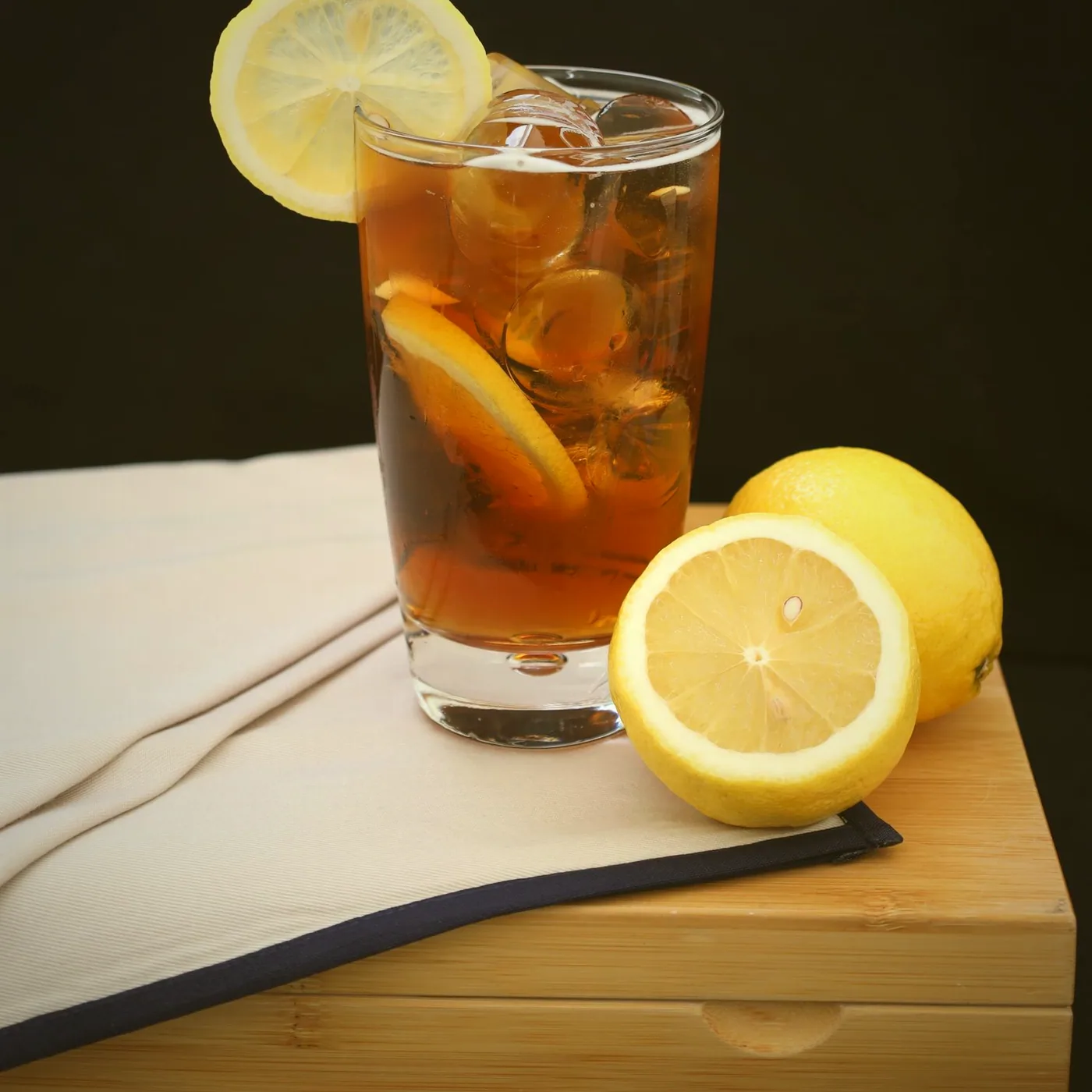 A glass of iced tea with lemon, ready at the counter